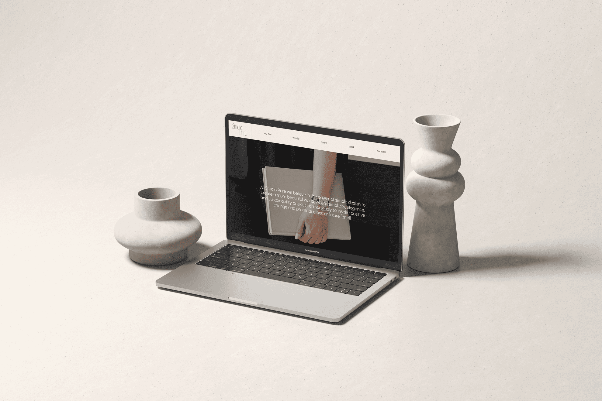 A laptop is sitting on a table next to vases and a vase, belonging to a WordPress Designer.