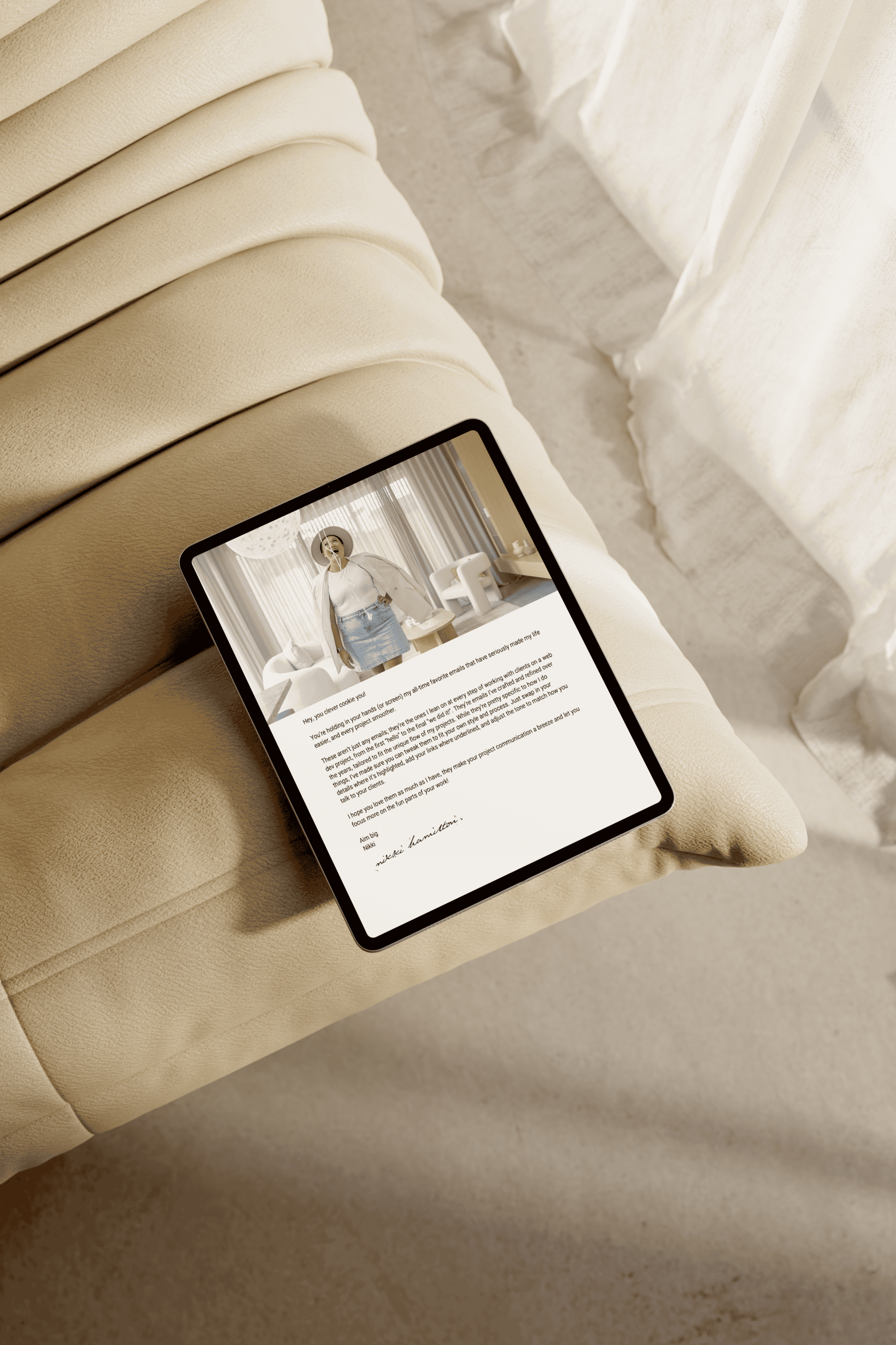 Tablet displaying a blog article with a photo of a woman in a cozy room, placed on a beige sofa beside a white pillow.